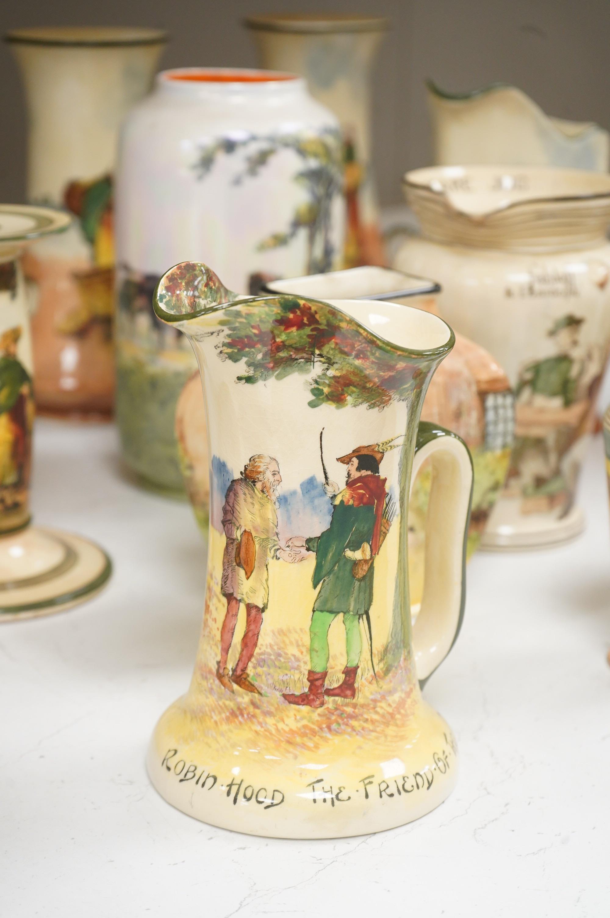 A collection of Royal Doulton series ware jugs, vases and candlesticks, largest 22cm high